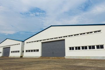 Industrial warehouse featuring two large doors, designed for electric car storage and efficient vehicle access.